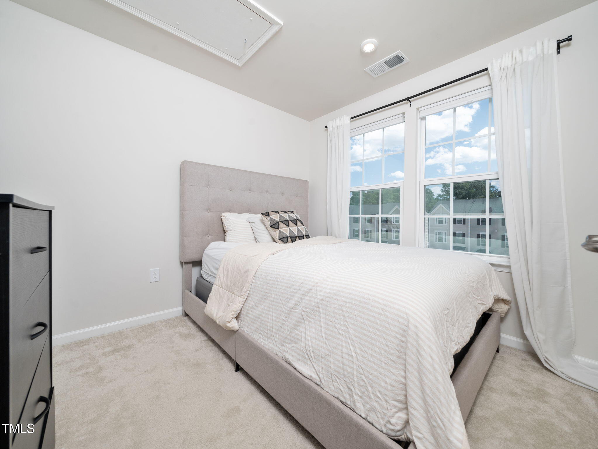 6429 Pathfinder Way Raleigh, NC 27616 - Photo 14 of 18 a large bed sitting in a bedroom next to a large window