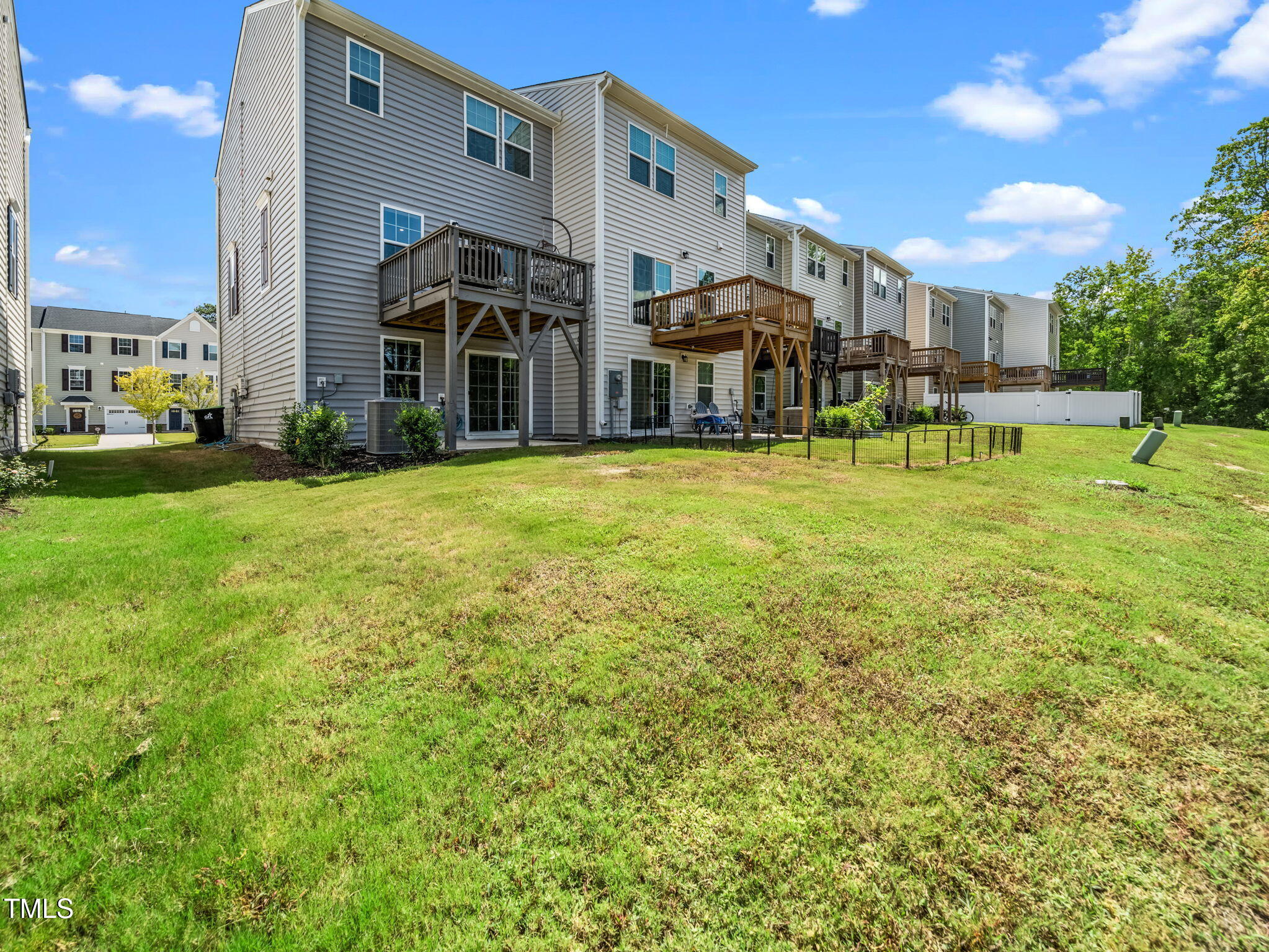 6429 Pathfinder Way Raleigh, NC 27616 - Photo 17 of 18 a front view of a building with a garden