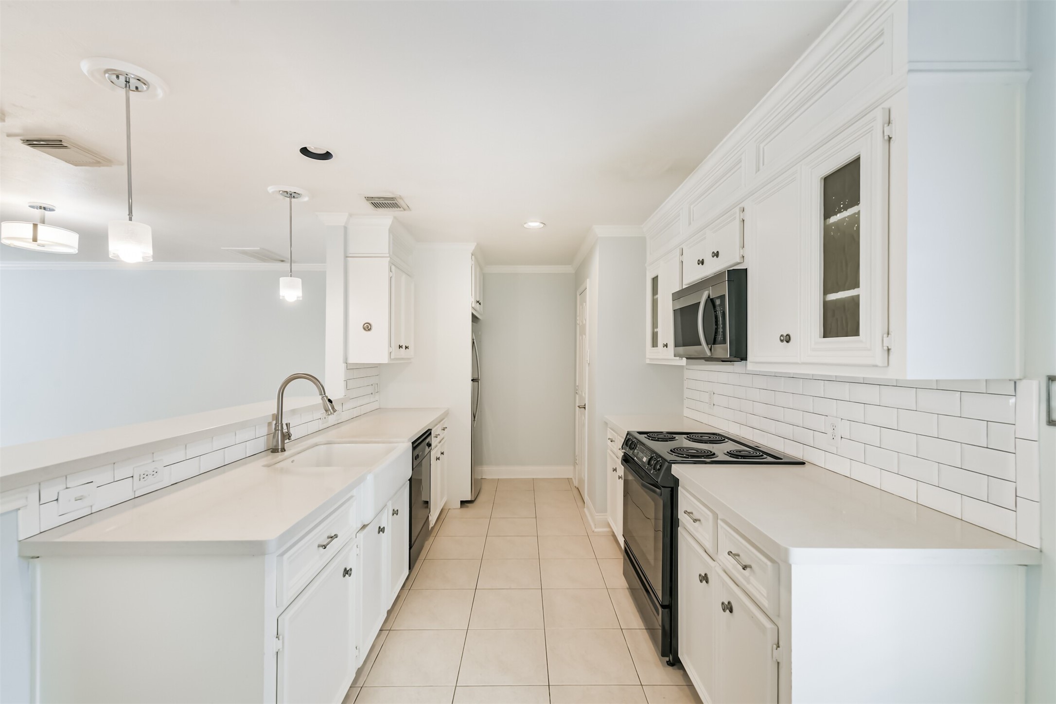 738 Redwing Pl Drive Houston, TX 77009 - Photo 6 of 23 A sleek, polished kitchen showcasing custom-designed cabinetry, clean lines, and a modern aesthetic ideal for everyday cooking and entertaining.
