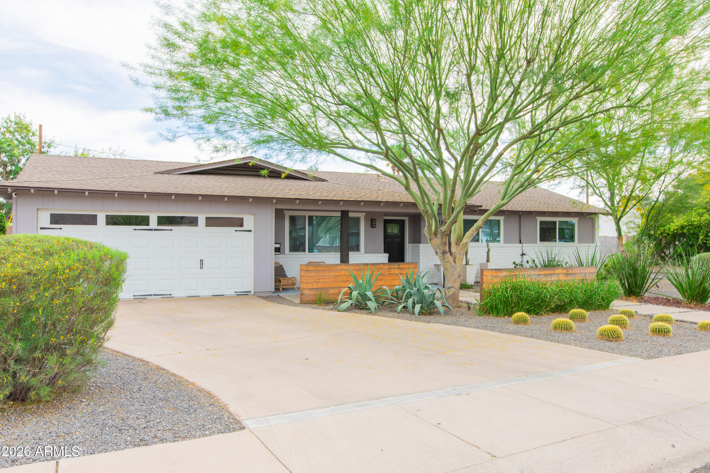 5541 East Cheery Lynn Road Phoenix, AZ 85018 - Photo 5 of 69 a front view of a house with a garden and trees