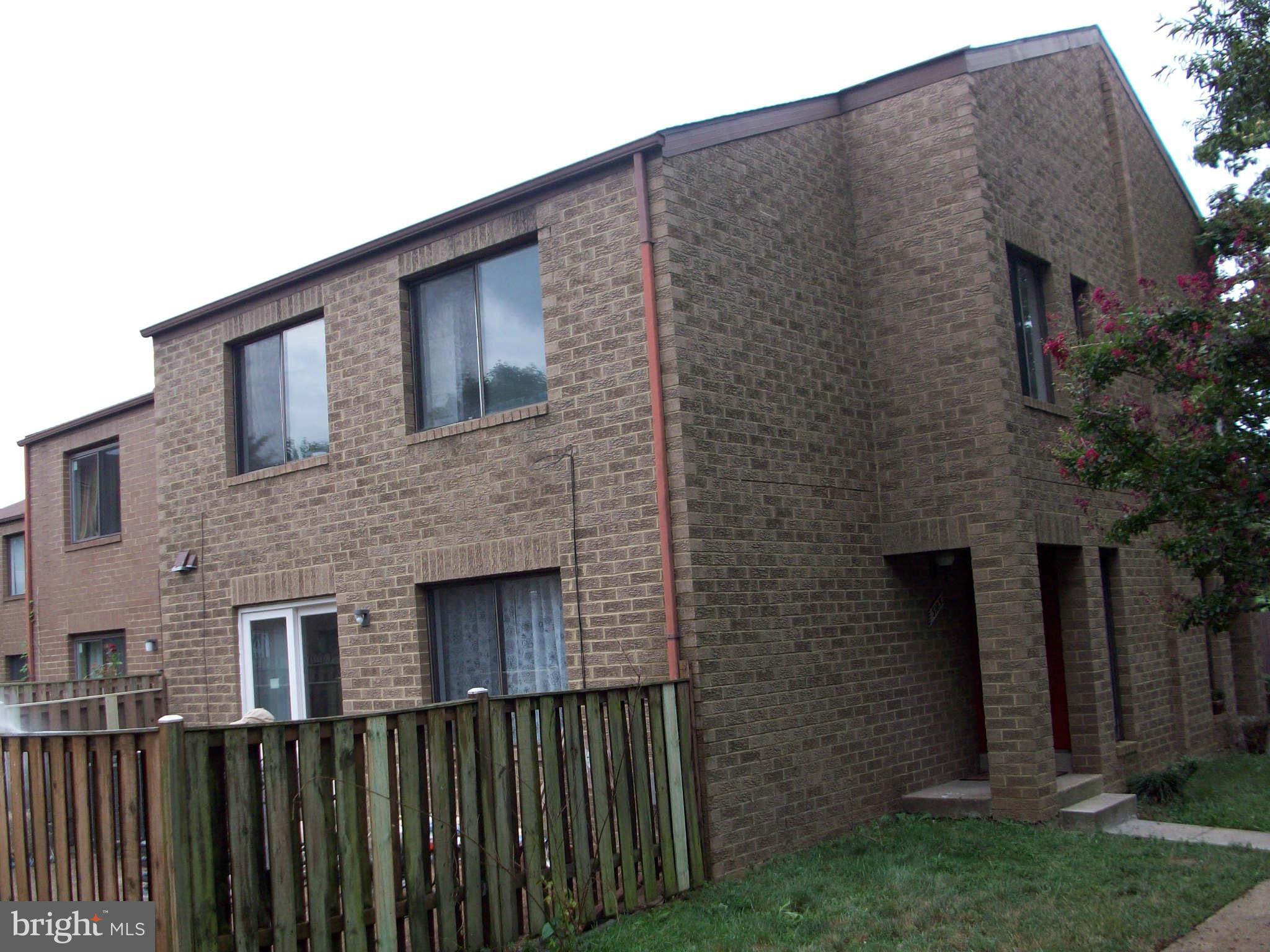 a brick house with a small yard