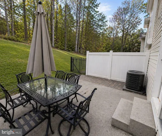 a view of a patio with a table chairs and a backyard