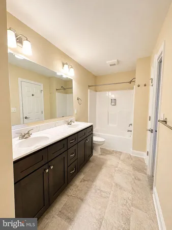 a spacious bathroom with a double vanity sink mirror double and shower