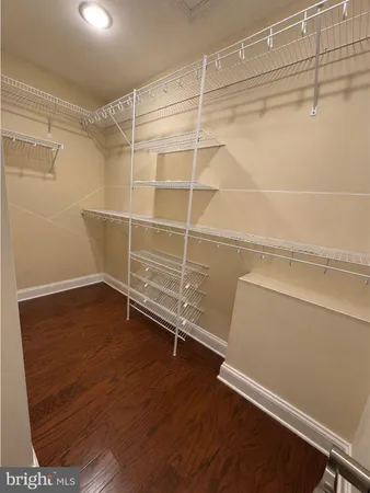 a view of a room with wooden floor and white walls