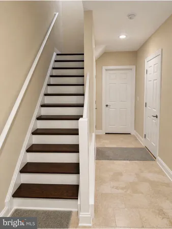 a view of entryway with wooden floor and white walls