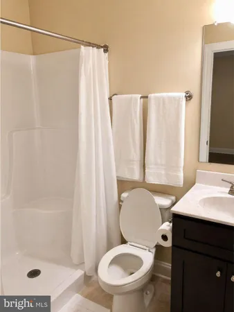 a white toilet sitting next to a bathroom sink