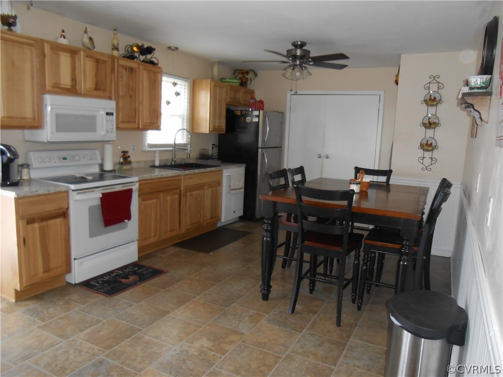 3132 Fielding Road Chester, VA 23831 - Photo 13 of 28 a kitchen with a dining table chairs and white appliances