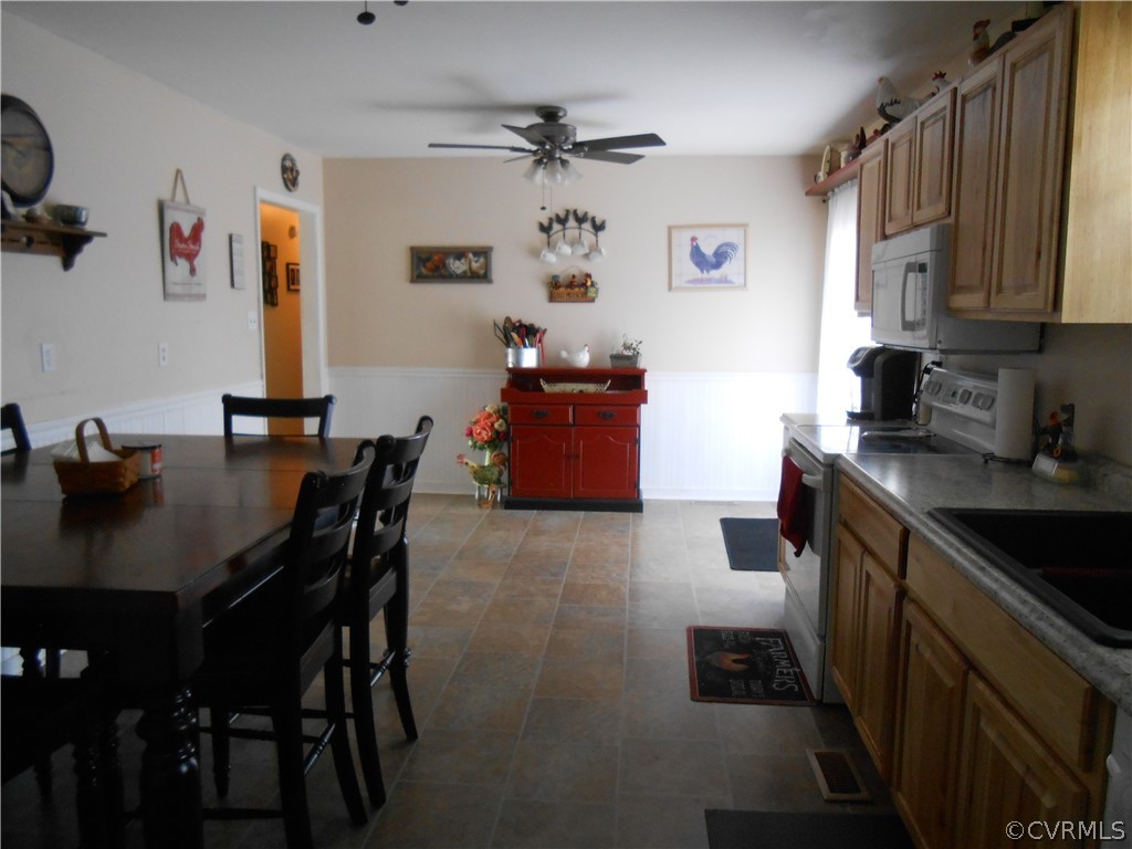 3132 Fielding Road Chester, VA 23831 - Photo 15 of 28 a kitchen with a table chairs refrigerator and cabinets
