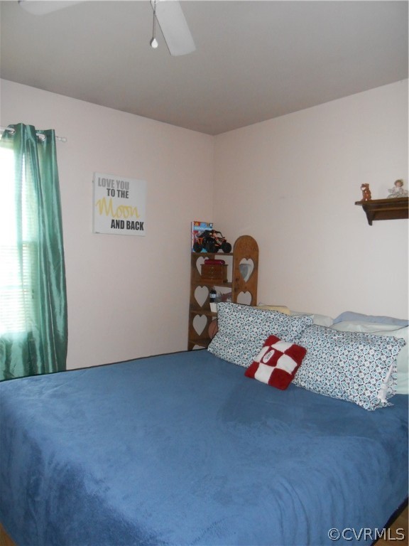 3132 Fielding Road Chester, VA 23831 - Photo 21 of 28 a bedroom with a bed and a chandelier