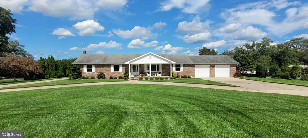 a front view of a house with yard and green space