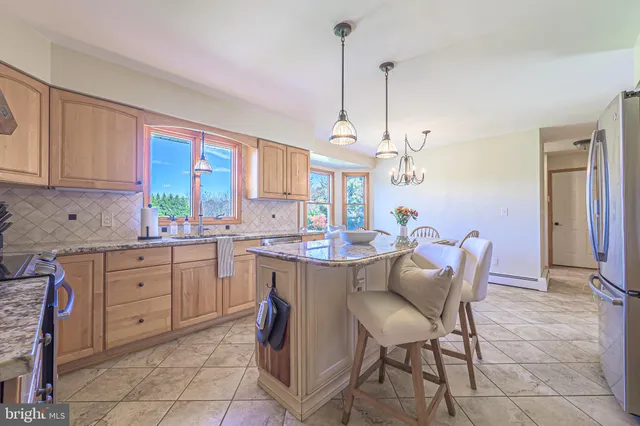 a kitchen with a sink a counter top space appliances and cabinets