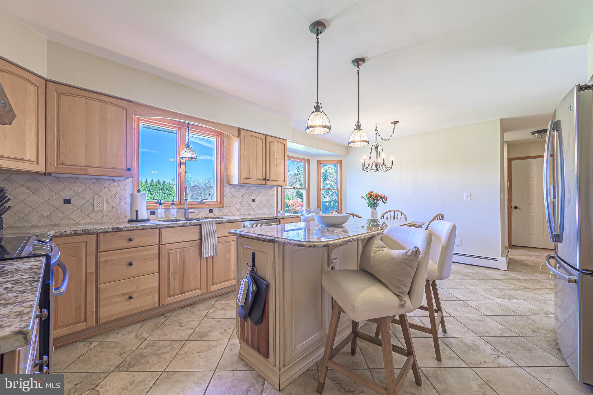 4926 Landis Avenue Vineland, NJ 08360 - Photo 18 of 73 a kitchen with a dining table chairs cabinets and stainless steel appliances
