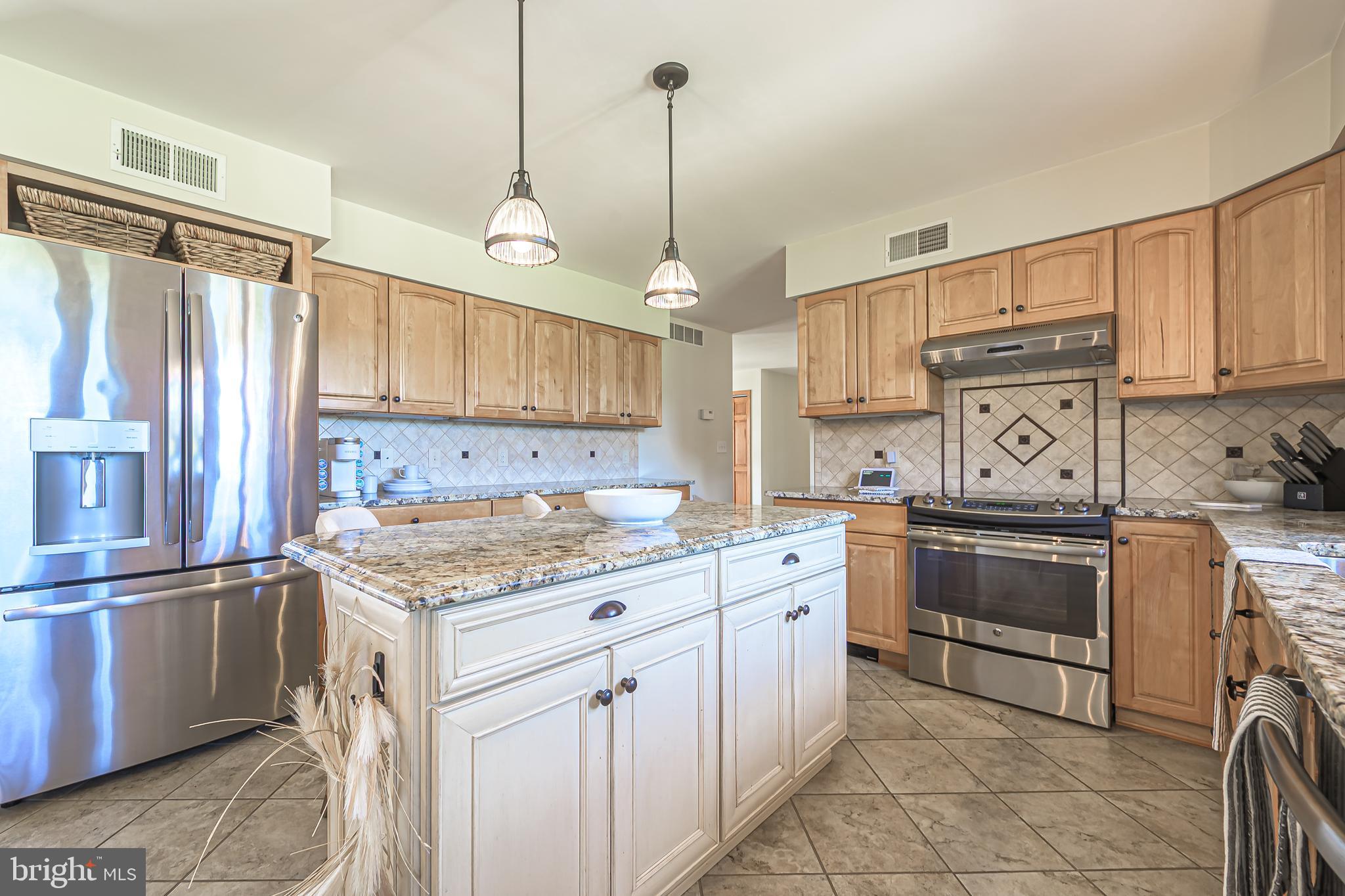 4926 Landis Avenue Vineland, NJ 08360 - Photo 19 of 73 a kitchen with granite countertop a sink stove and refrigerator