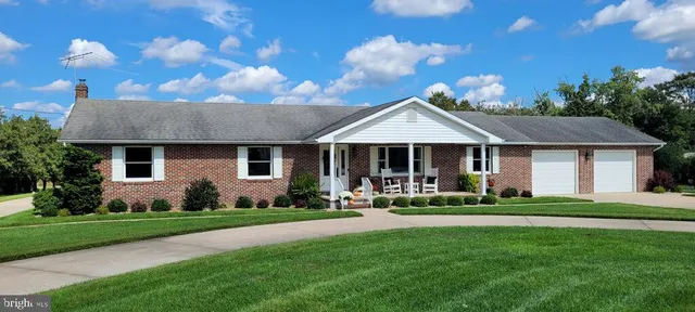 a front view of a house with a yard and porch