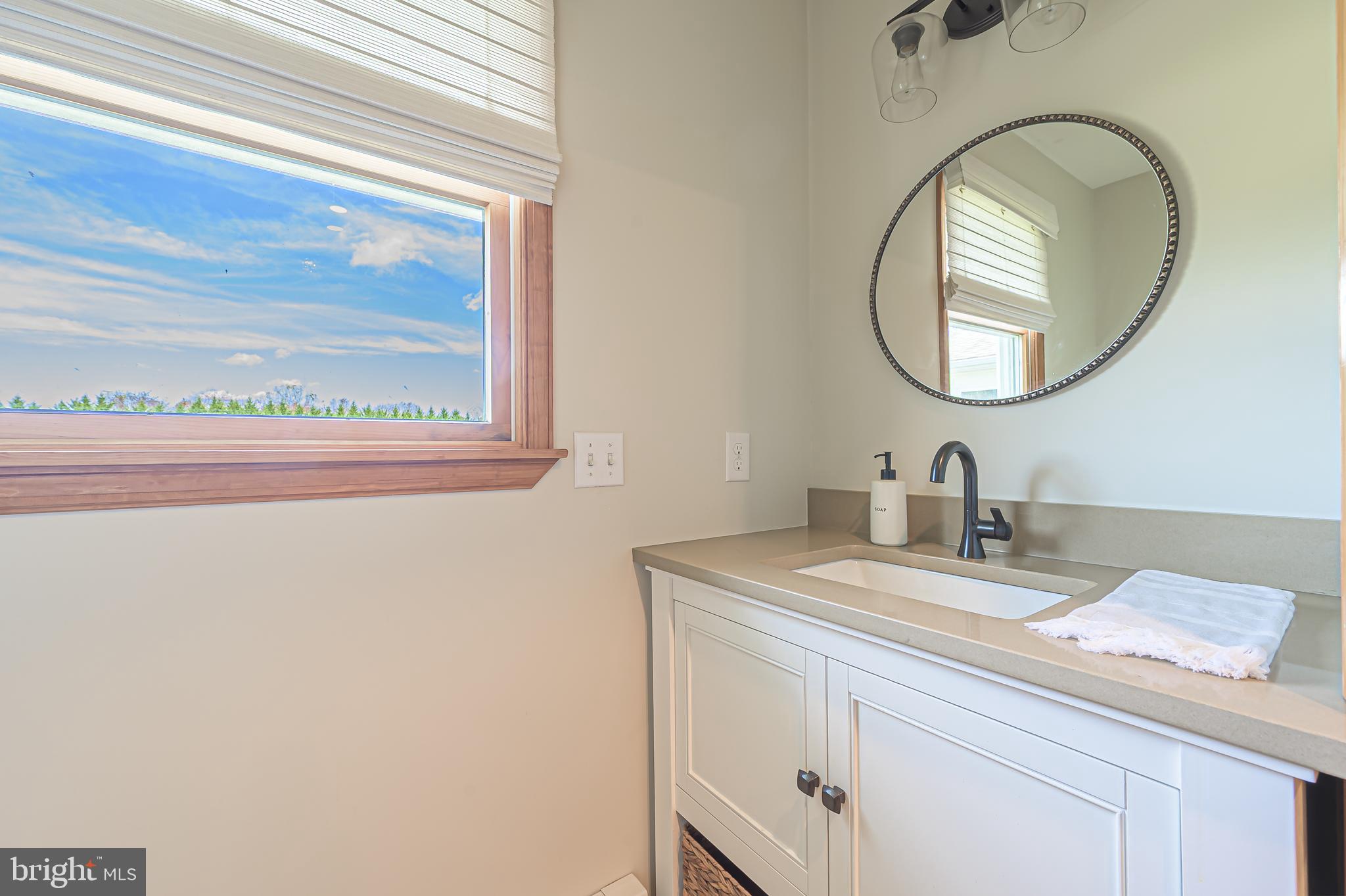 4926 Landis Avenue Vineland, NJ 08360 - Photo 29 of 73 a bathroom with a sink and a mirror
