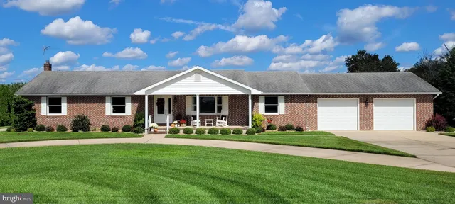 a front view of a house with a yard table and chairs