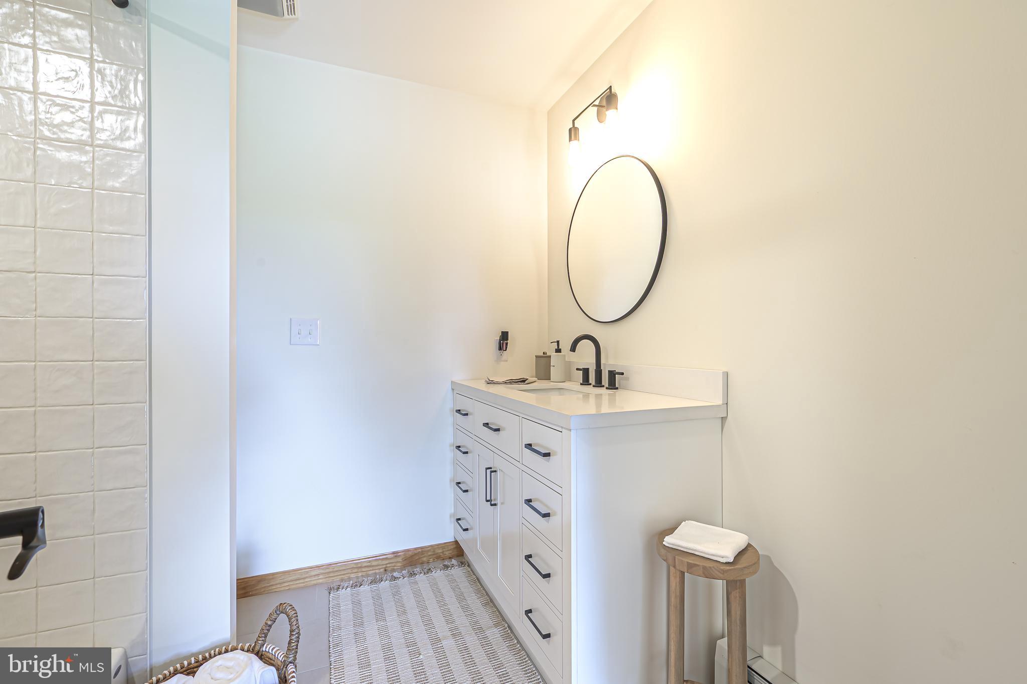 4926 Landis Avenue Vineland, NJ 08360 - Photo 33 of 73 a bathroom with a sink and a mirror