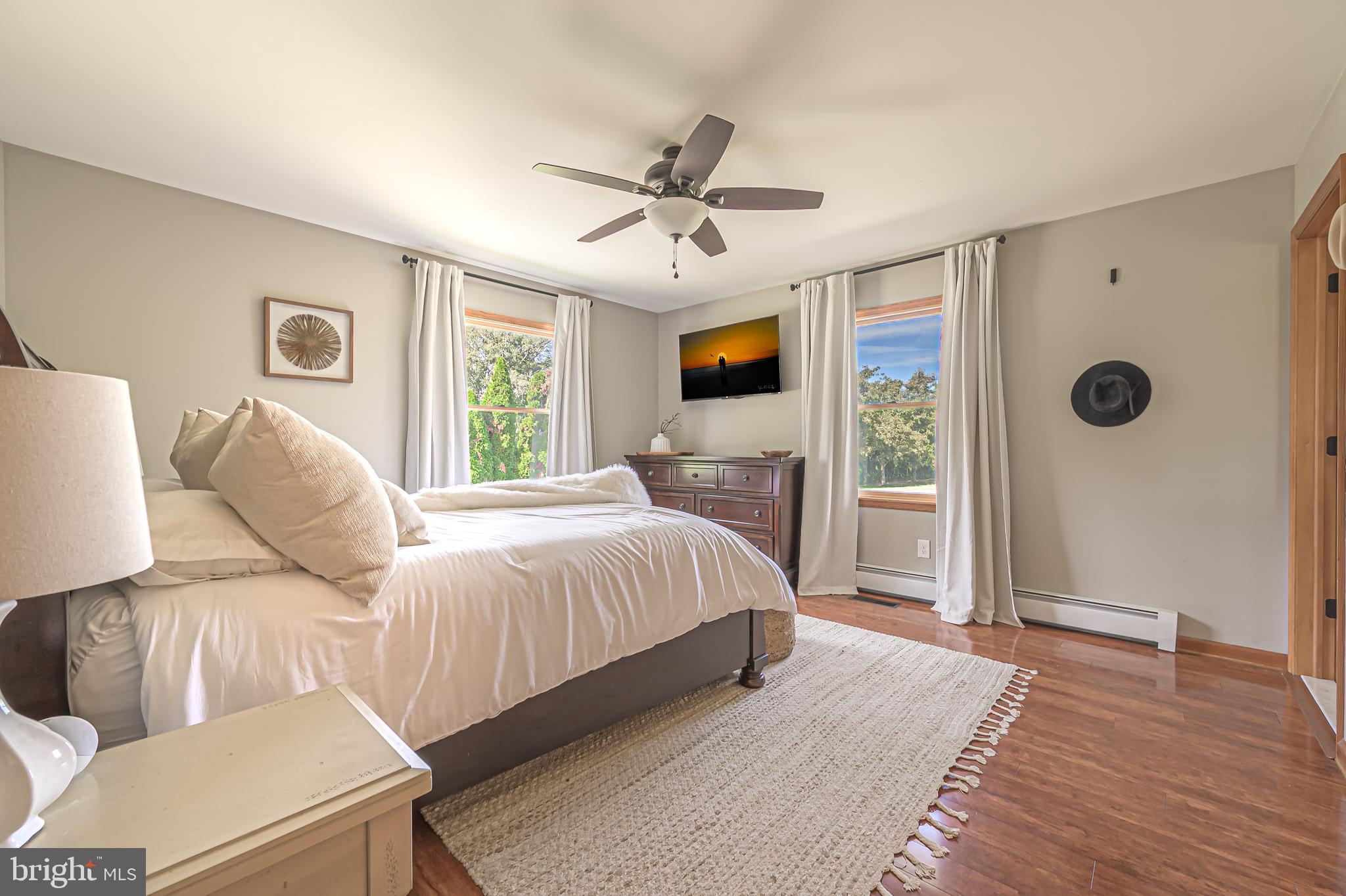4926 Landis Avenue Vineland, NJ 08360 - Photo 36 of 73 a spacious bedroom with a bed and a flat screen tv