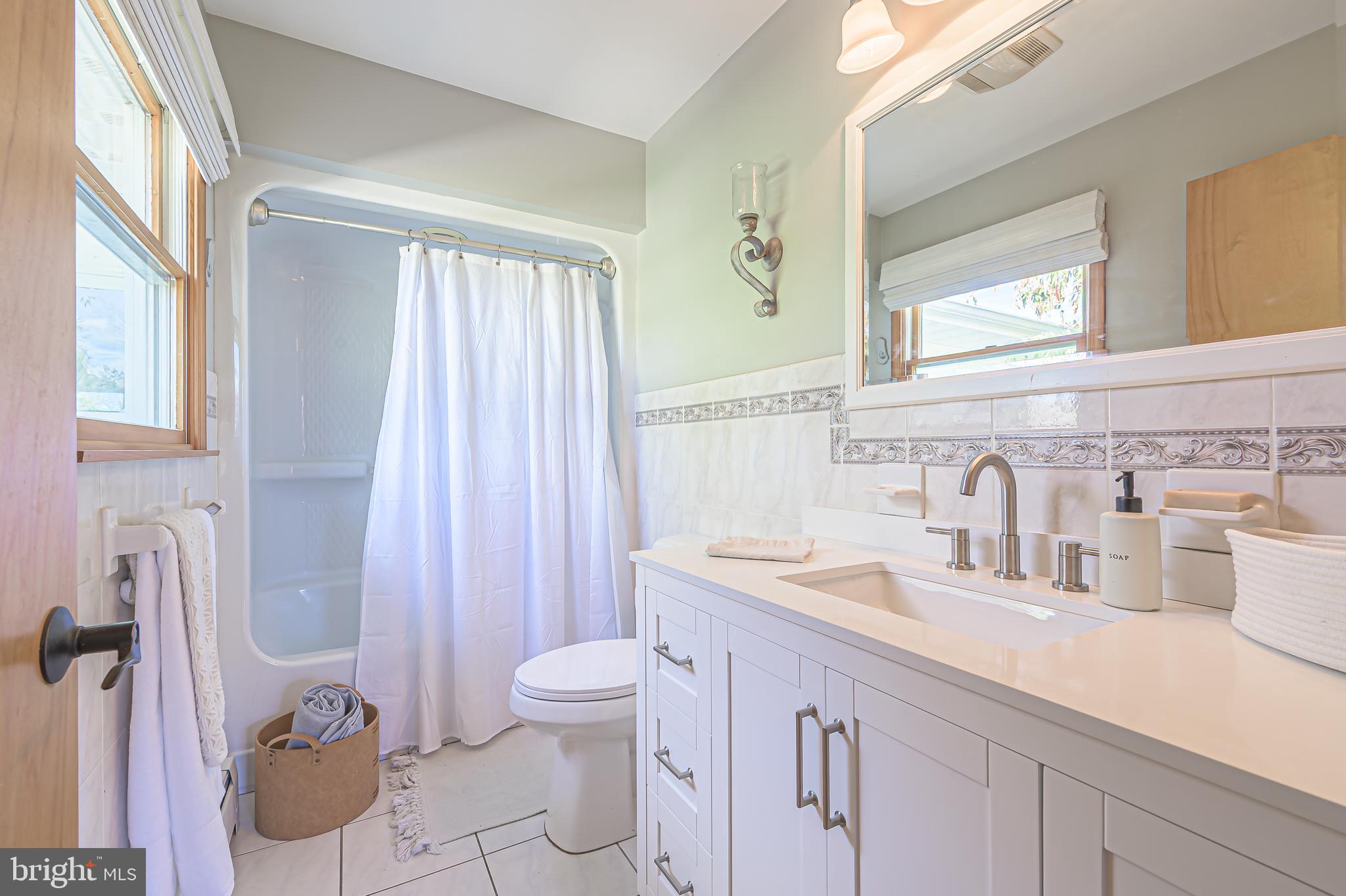 4926 Landis Avenue Vineland, NJ 08360 - Photo 37 of 73 a bathroom with a granite countertop sink and a mirror