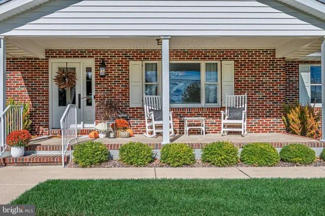 a front view of a house with a yard and plants