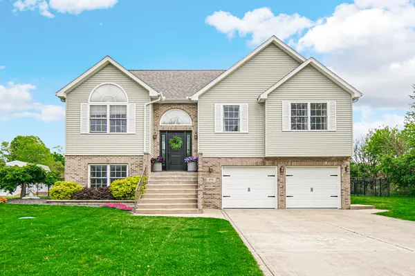 a front view of a house with a yard and garage