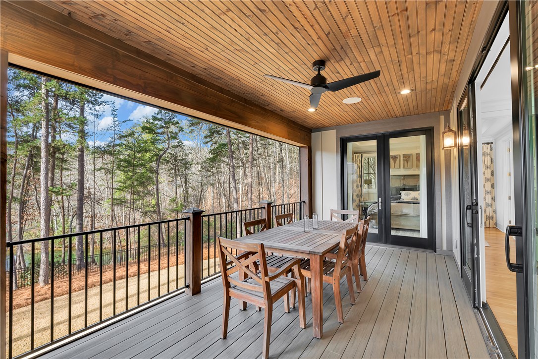 243 Quay Court Sunset, SC 29685 - Photo 14 of 46 This spacious deck offers a tranquil forest view, perfect for outdoor relaxation and dining.