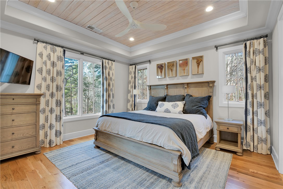 243 Quay Court Sunset, SC 29685 - Photo 15 of 46 This serene bedroom offers ample natural light and a charming wood-paneled ceiling.