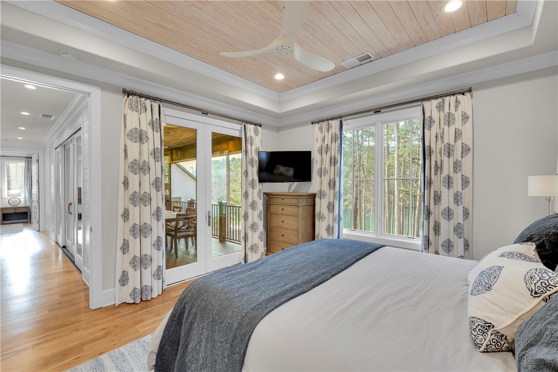 243 Quay Court Sunset, SC 29685 - Photo 16 of 46 This serene primary bedroom offers direct access to an outdoor living space.