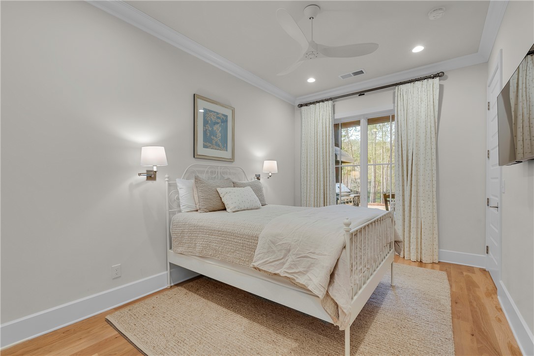 243 Quay Court Sunset, SC 29685 - Photo 30 of 46 This bright bedroom features direct outdoor access and elegant hardwood flooring.