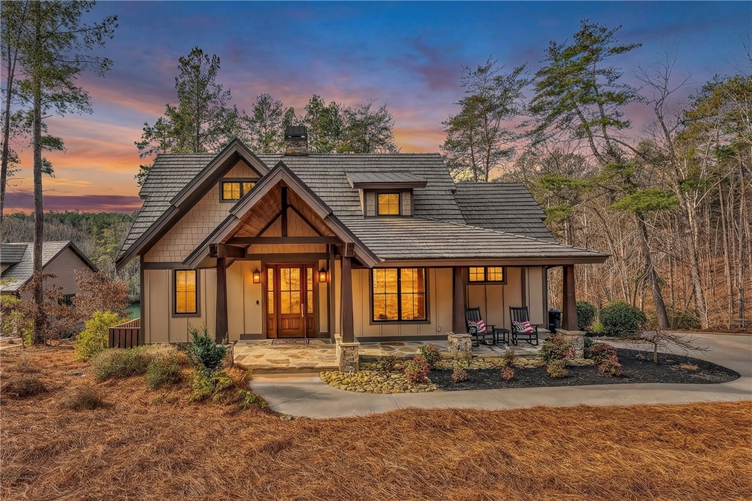 243 Quay Court Sunset, SC 29685 - Photo 44 of 46 This charming home features a welcoming porch, a sturdy shingle roof, and a stone and wood exterior.