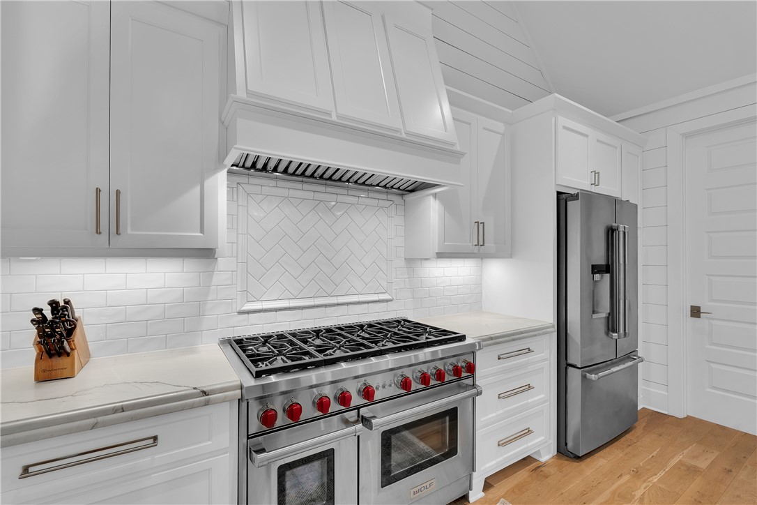 243 Quay Court Sunset, SC 29685 - Photo 10 of 46 This modern kitchen features high-end appliances, sleek cabinetry, and ample counter space.