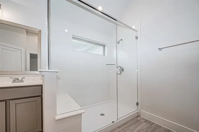 a bathroom with a shower sink and mirror