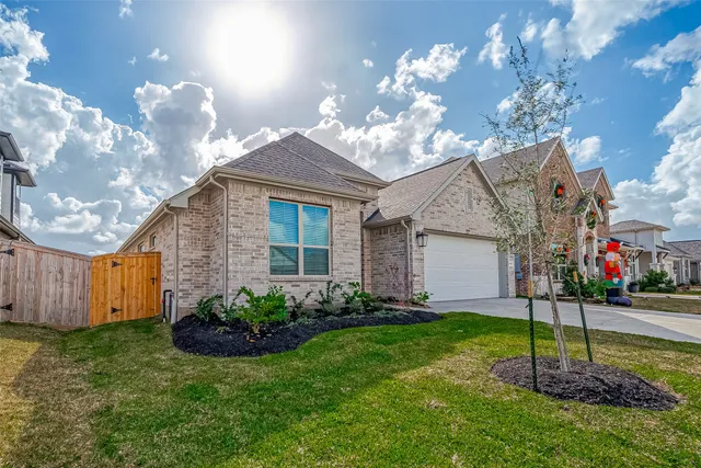 a view of a house with a yard and a garden