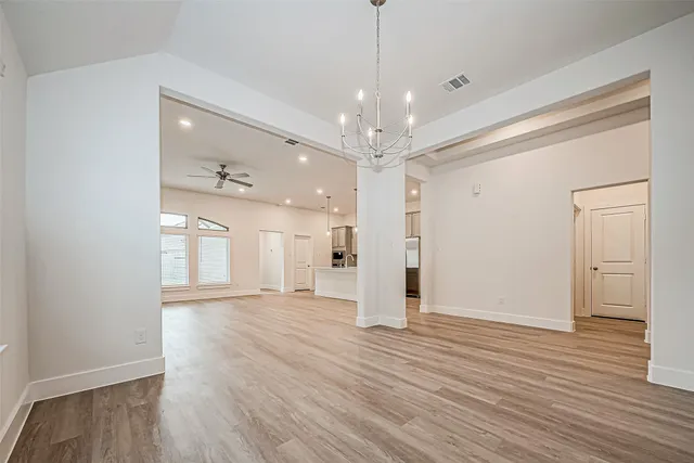 a view of an empty room and wooden floor