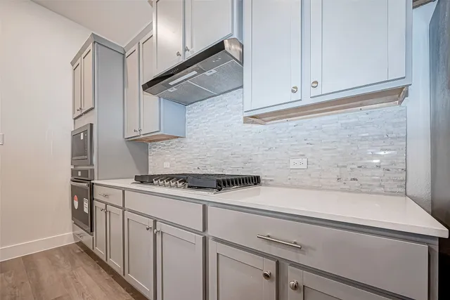 a kitchen with white cabinets and white appliances
