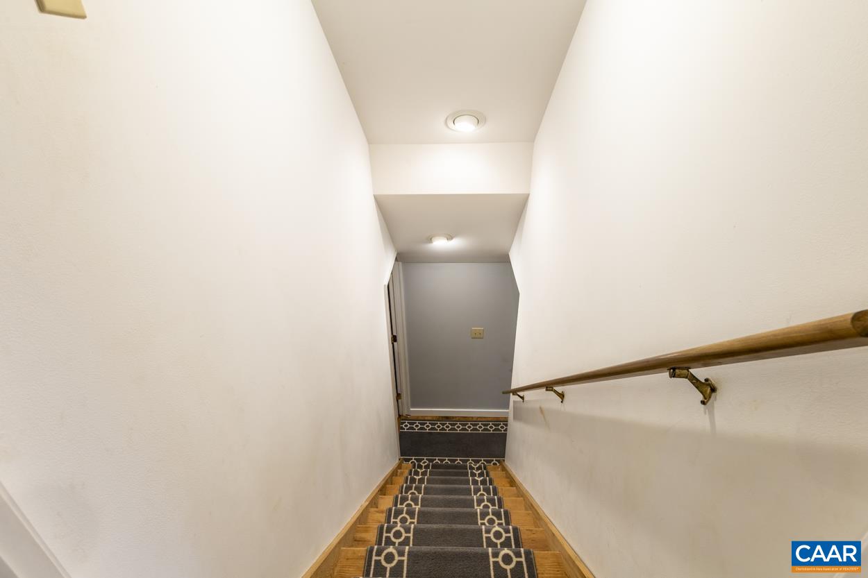 136 Buffalo Run Road Stanardsville, VA 22973 - Photo 39 of 64 a view of a hallway with wooden floor and a potted plant