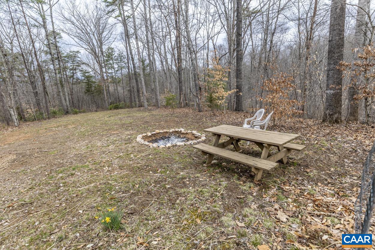 136 Buffalo Run Road Stanardsville, VA 22973 - Photo 54 of 64 a backyard of a house with table and chairs
