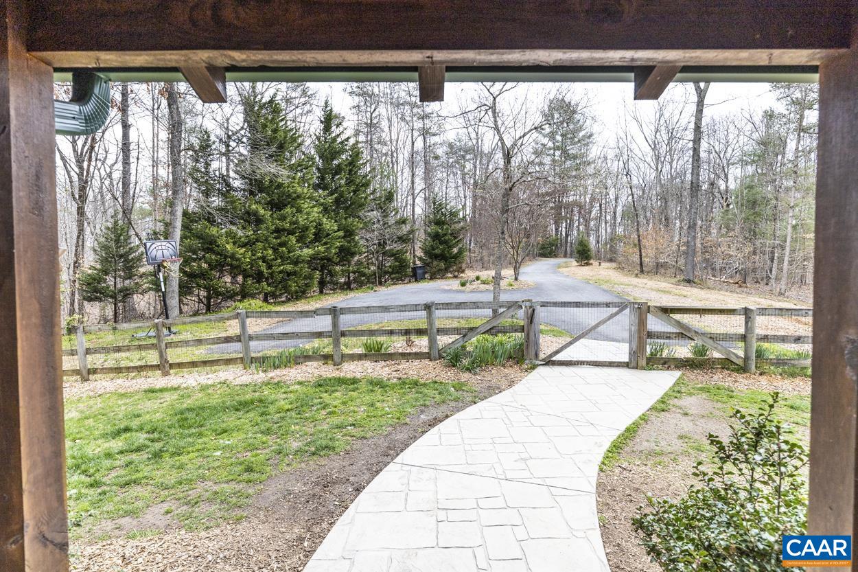 136 Buffalo Run Road Stanardsville, VA 22973 - Photo 60 of 64 a view of a chair and fire pit in the back yard of the house