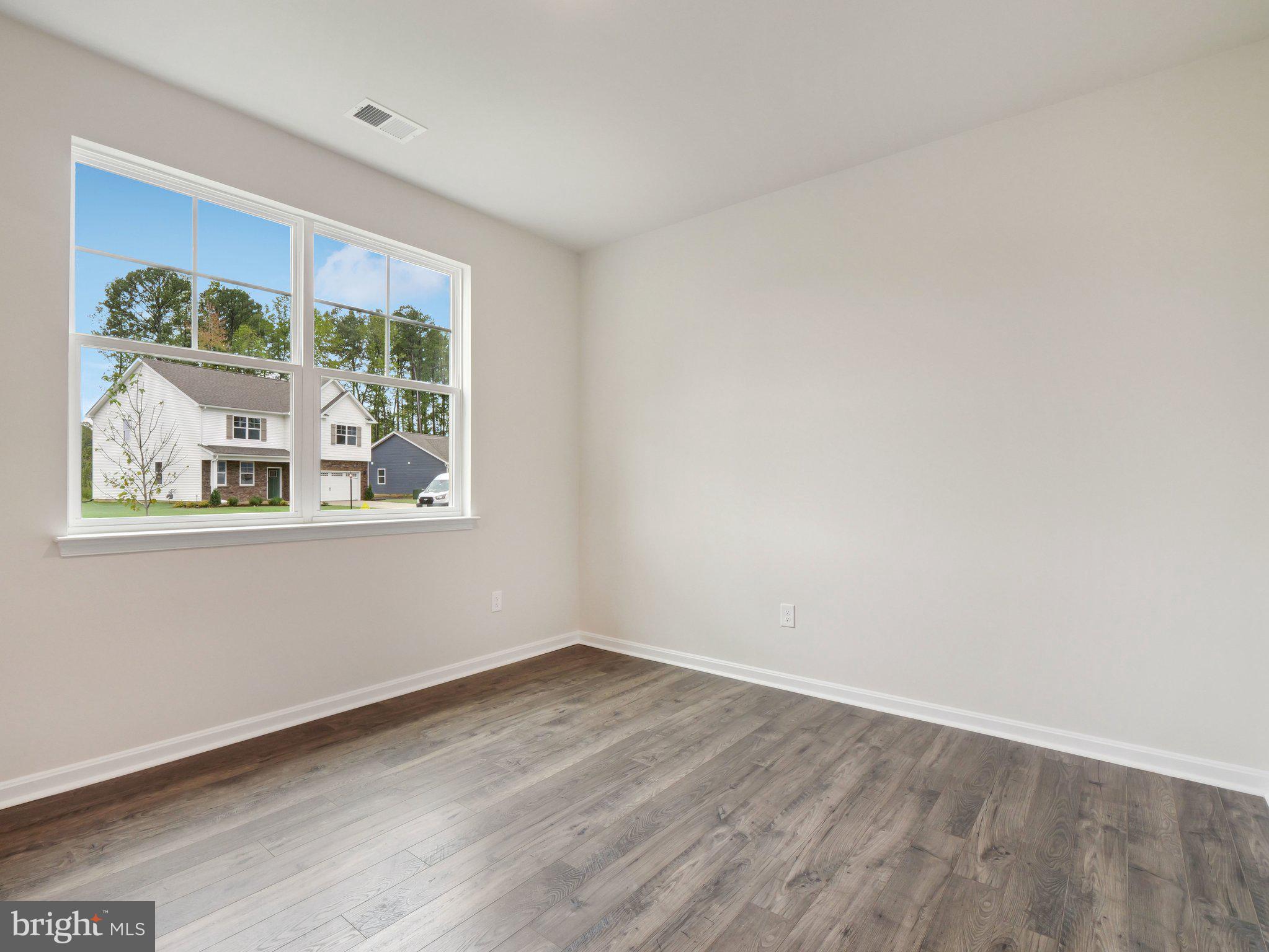 6302 Sterling Way Ruther Glen, VA 22546 - Photo 11 of 31 wooden floor in an empty room with a window