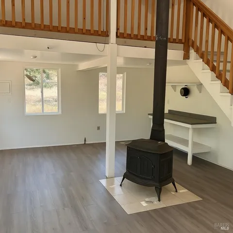a living room with wooden floor and furniture