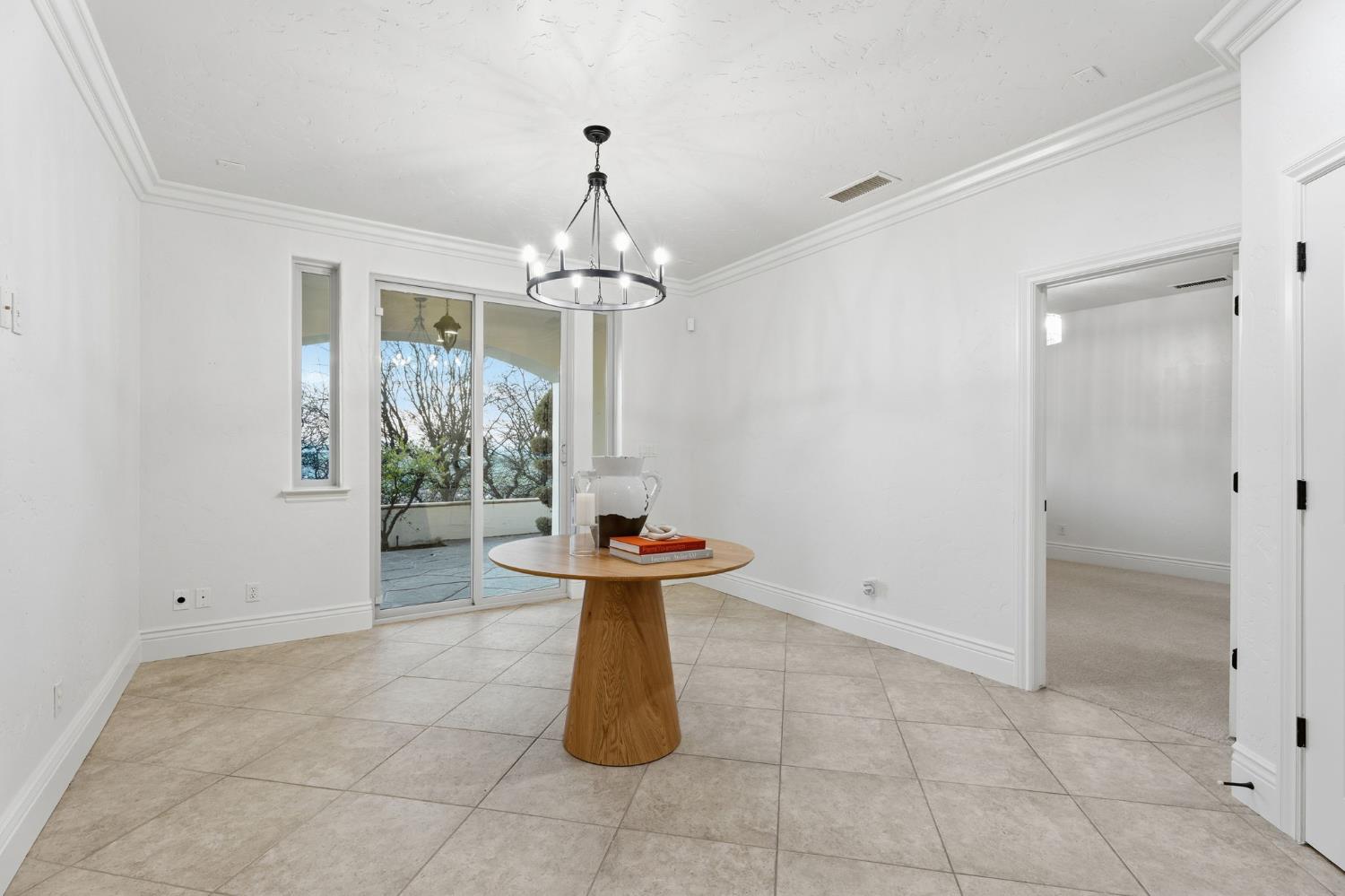 22221 Masters Drive Friant, CA 93626 - Photo 17 of 87 a view of a hallway with windows and chandelier
