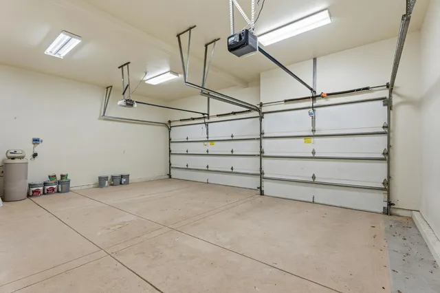 a view of a dining room and livingroom with furniture wooden floor a chandelier