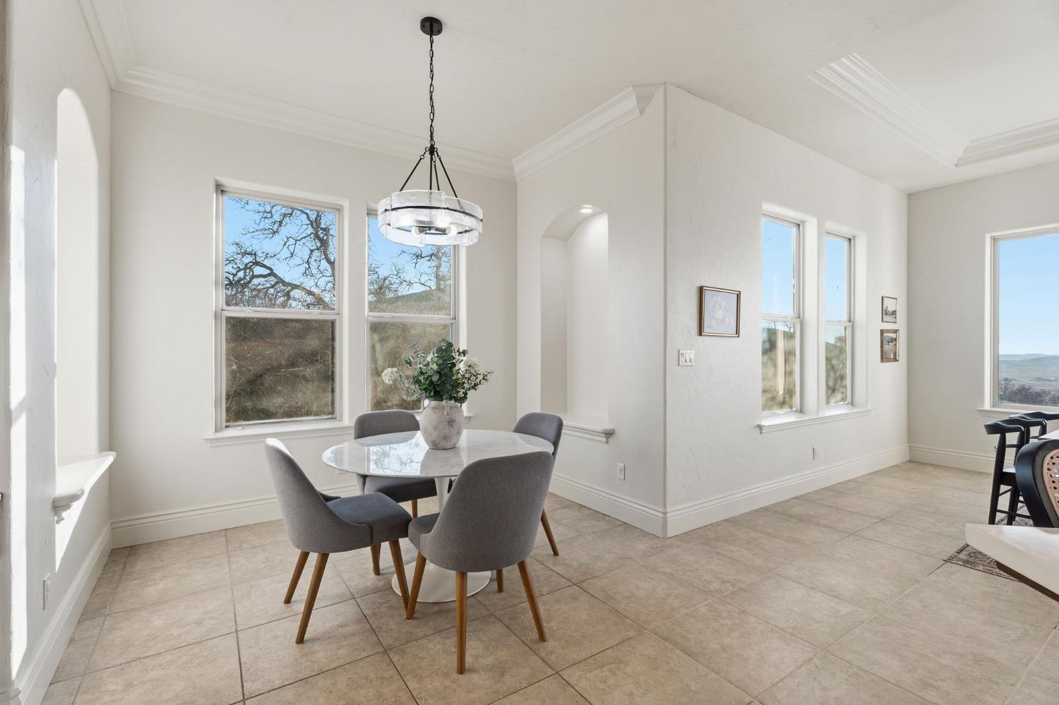 22221 Masters Drive Friant, CA 93626 - Photo 34 of 87 a dining room with furniture a chandelier and window