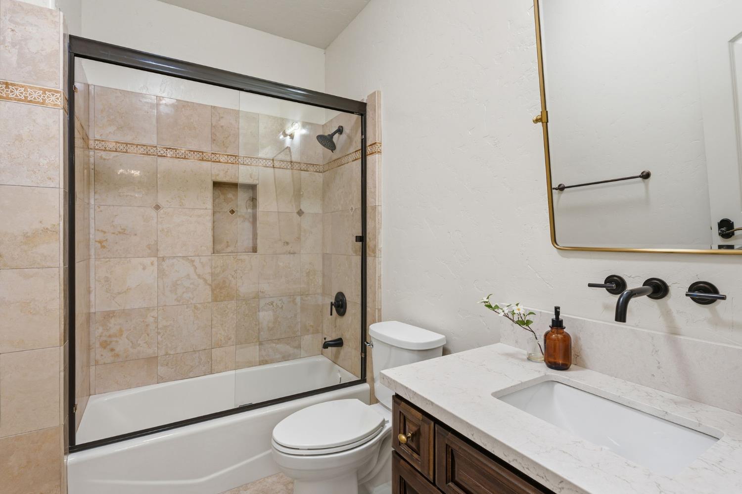 22221 Masters Drive Friant, CA 93626 - Photo 44 of 87 a bathroom with a sink a toilet and shower