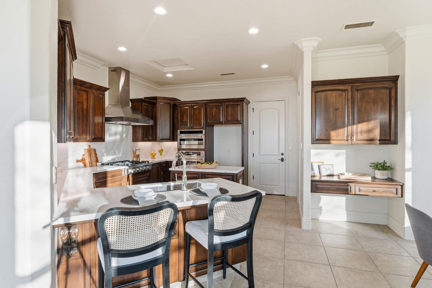 22221 Masters Drive Friant, CA 93626 - Photo 74 of 87 a kitchen with a dining table chairs and refrigerator