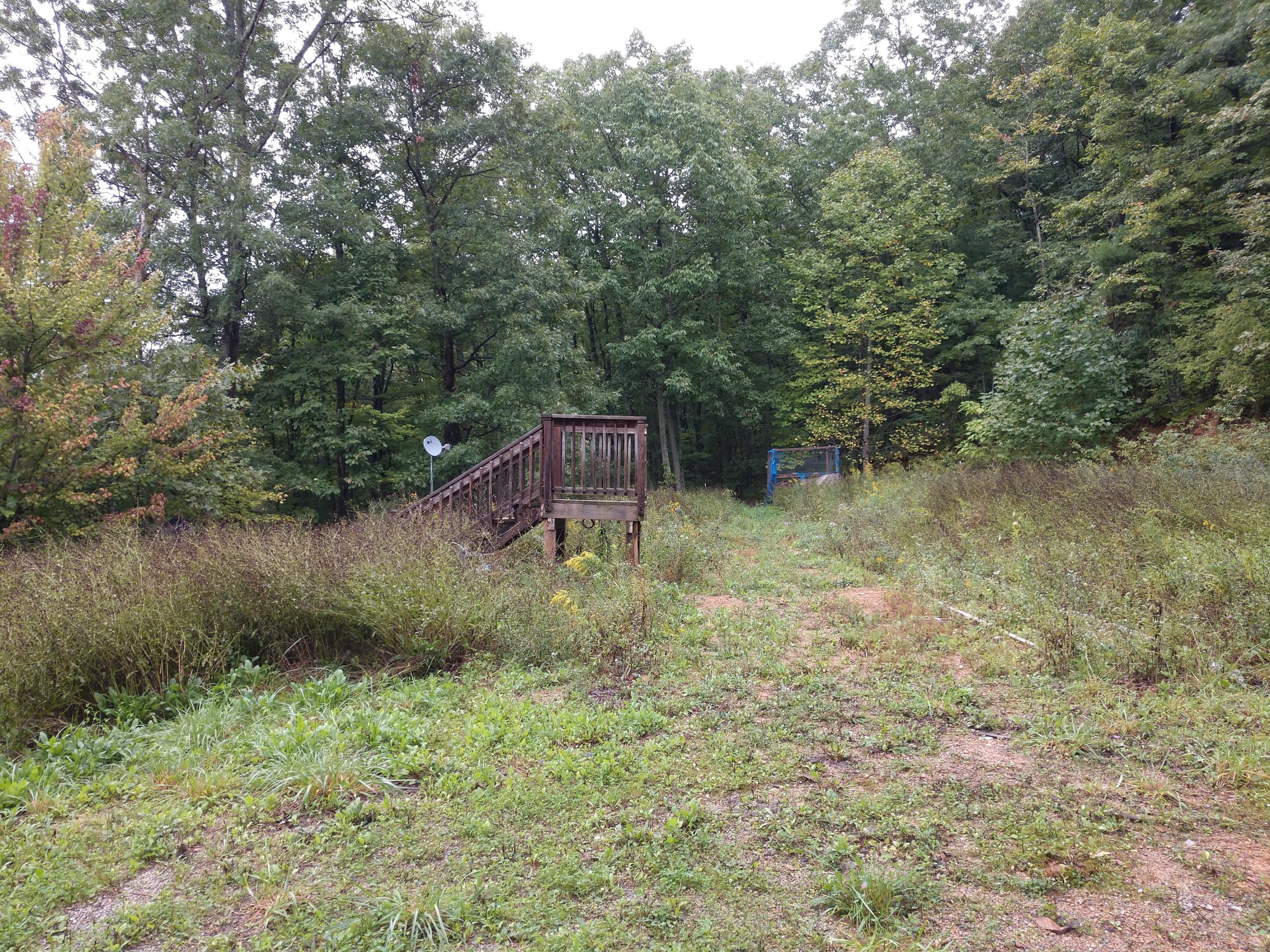 1090 Lexington Lane Riner, VA 24149 - Photo 5 of 12 a backyard of a house with lots of green space and lake view