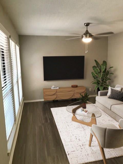 18240 Midway Road, Unit 303 Dallas, TX 75287 - Photo 5 of 21 Wood-finish flooring throughout, ceiling fan with integrated lighting, and multiple windows with horizontal blinds