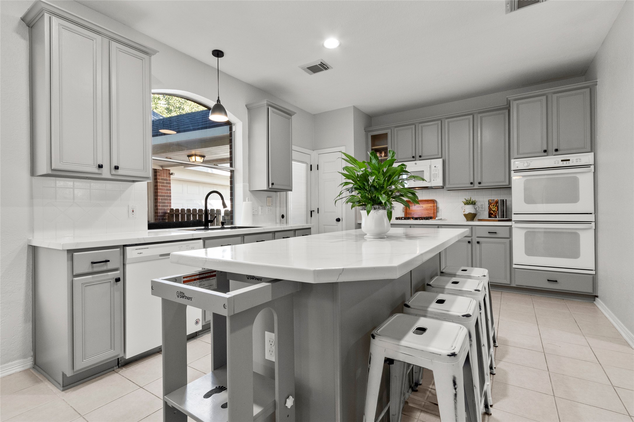 9114 Kirkstone Drive Spring, TX 77379 - Photo 11 of 31 a kitchen with kitchen island a sink appliances and cabinets