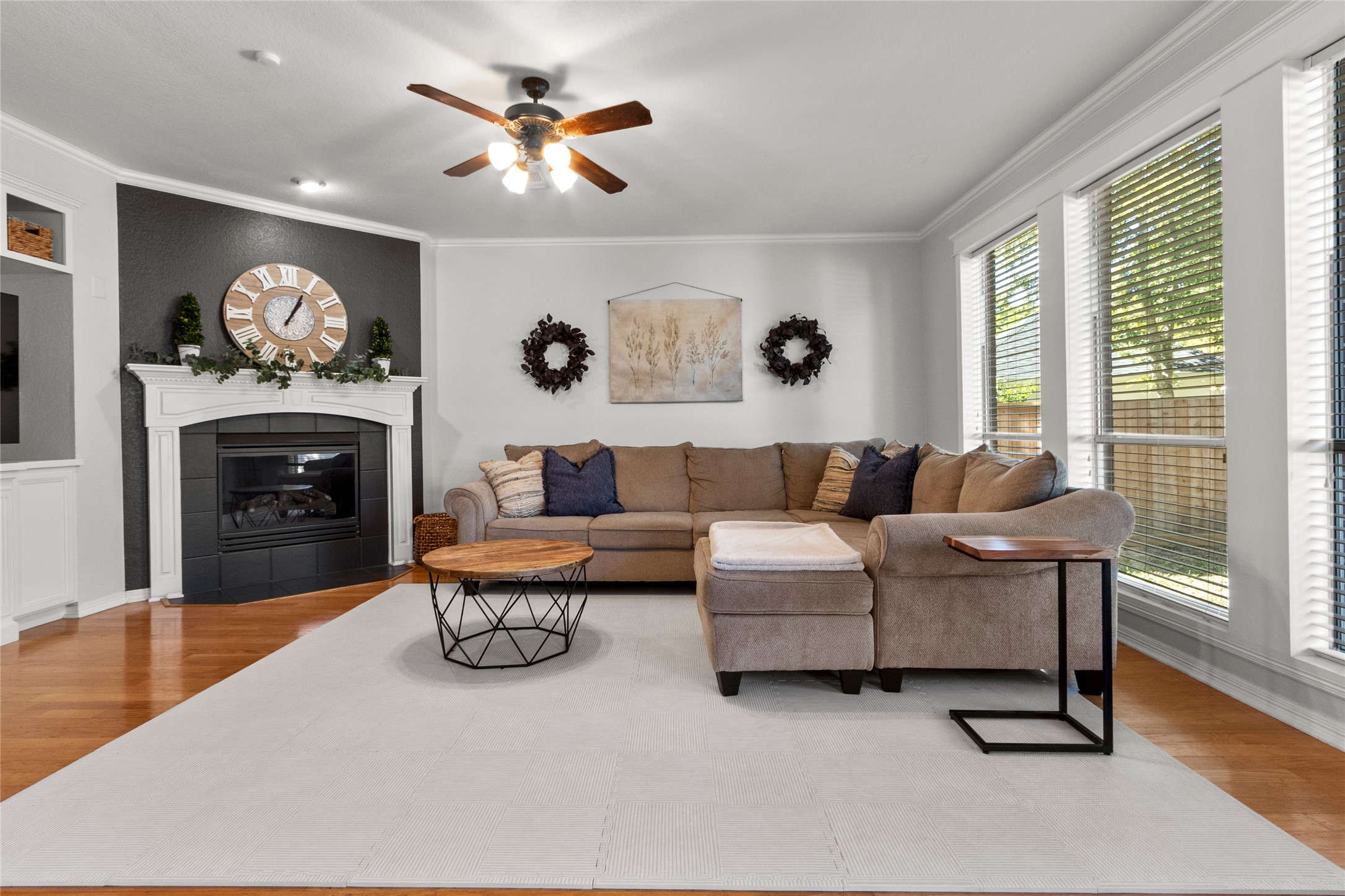 9114 Kirkstone Drive Spring, TX 77379 - Photo 12 of 31 a living room with furniture a fireplace and a flat screen tv