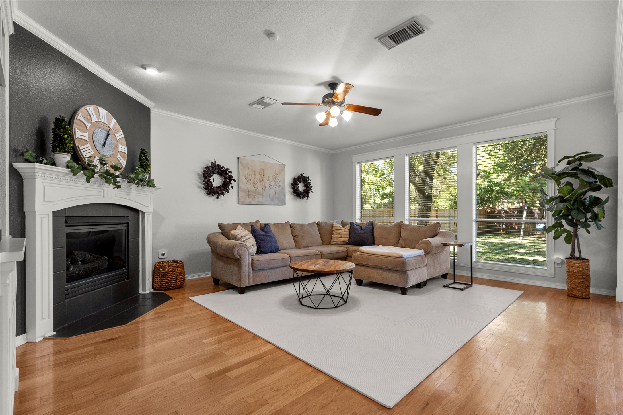 9114 Kirkstone Drive Spring, TX 77379 - Photo 15 of 31 a living room with furniture a chandelier and a fireplace